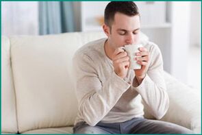 A man drinks tea with mint, wanting to cure erectile dysfunction. 